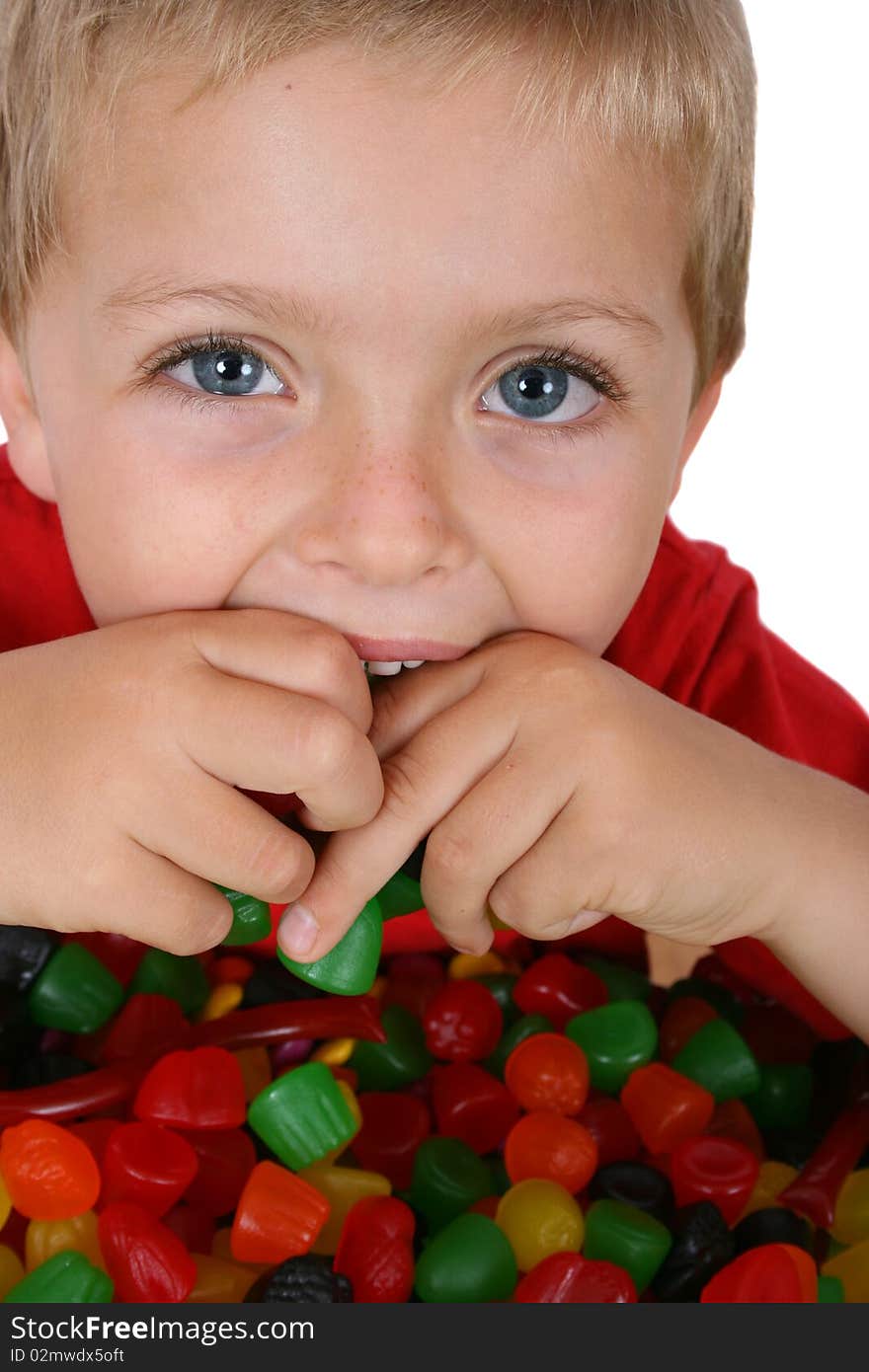 Young boy with a table full of colorful sweets. Young boy with a table full of colorful sweets