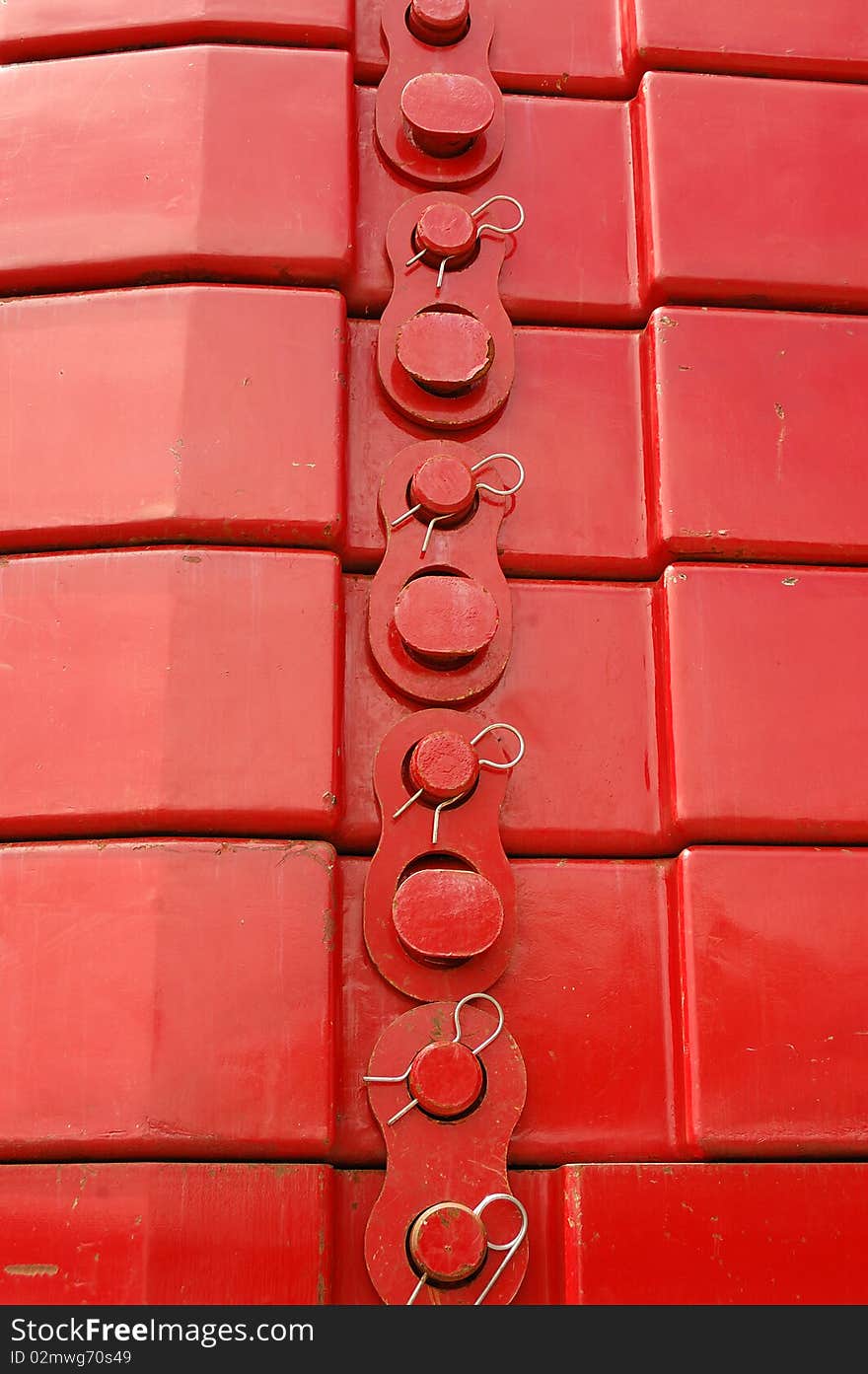 Closeup of a stack of red steel counterweights for a large crane with locks and pins. Closeup of a stack of red steel counterweights for a large crane with locks and pins.