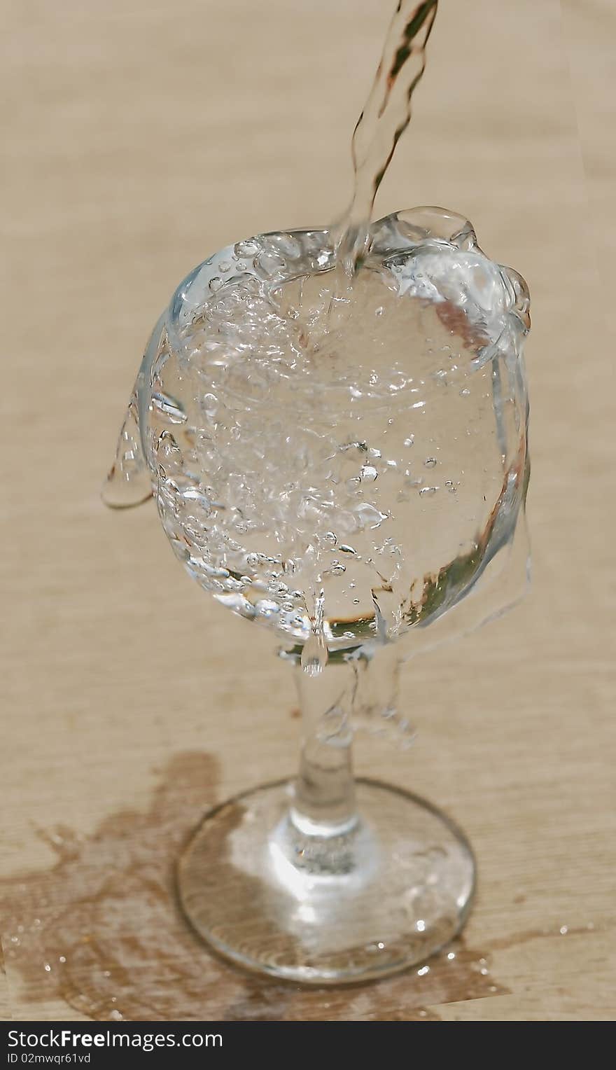 Glass in which flows pure water from a bottle. Glass in which flows pure water from a bottle