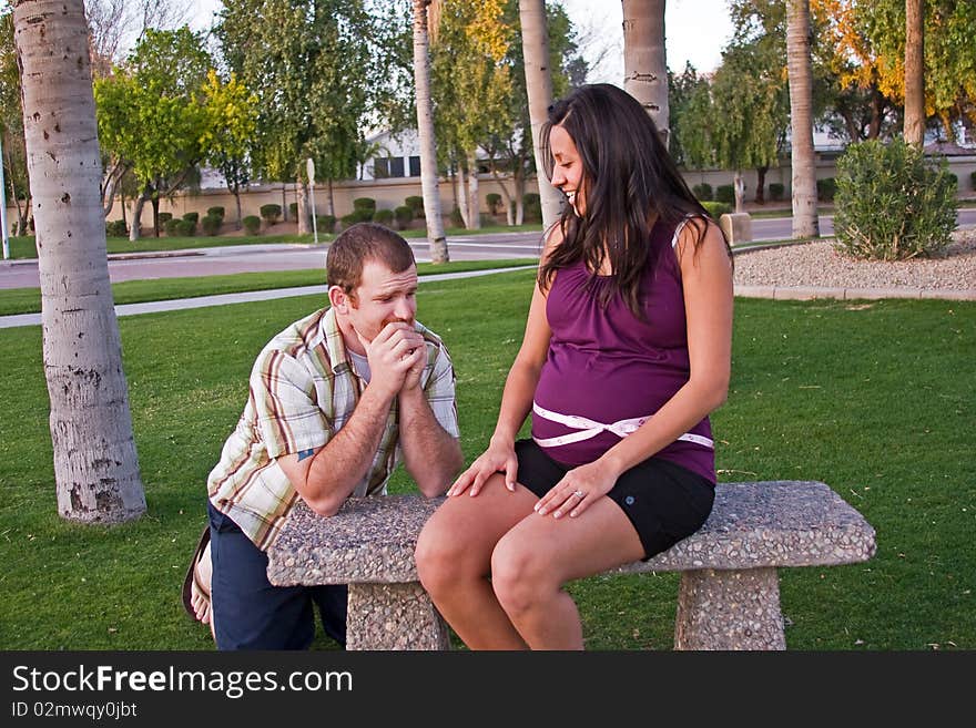 A young father contemplates his unborn baby. A young father contemplates his unborn baby.