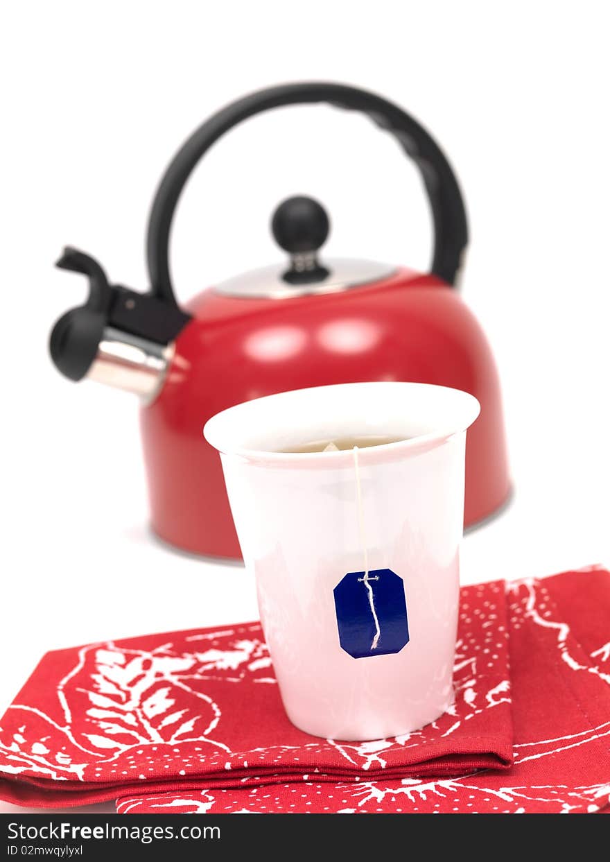 A stove top kettle and a cup of tea on a kitchen bench. A stove top kettle and a cup of tea on a kitchen bench