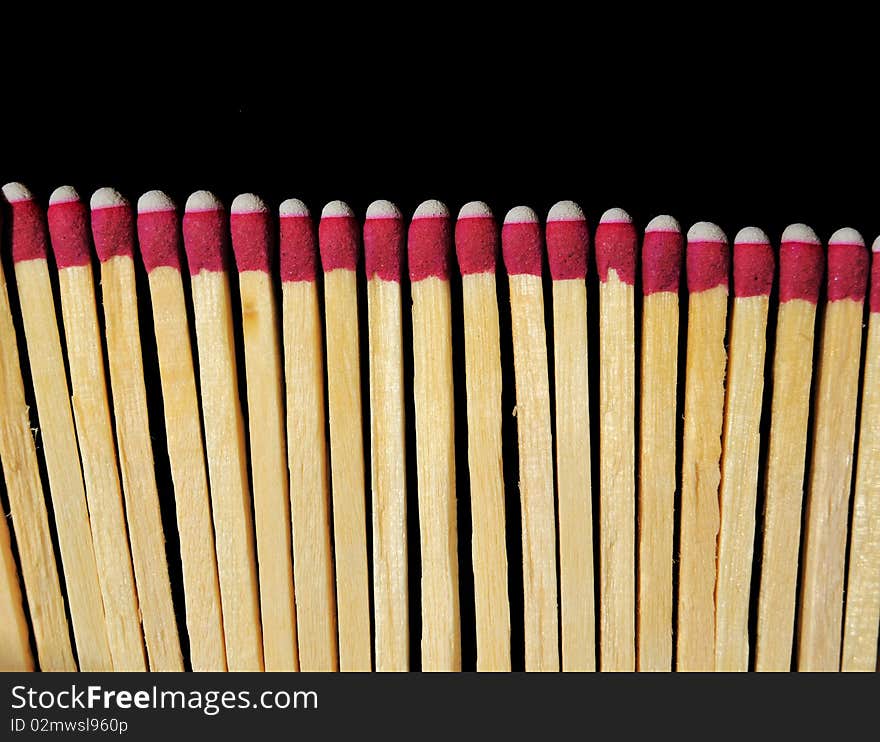 A bunch of wooden matches isolated on a black background. A bunch of wooden matches isolated on a black background