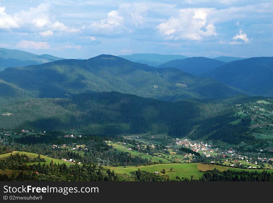 Panorama of Carpathian village with mountains and sky