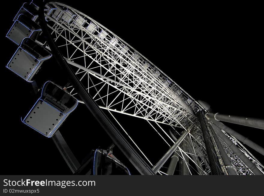 A dynamic angle of the ferris wheel at night