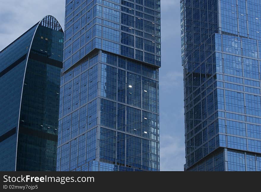 Reflection of a cloudy sky in glass wall of an office building