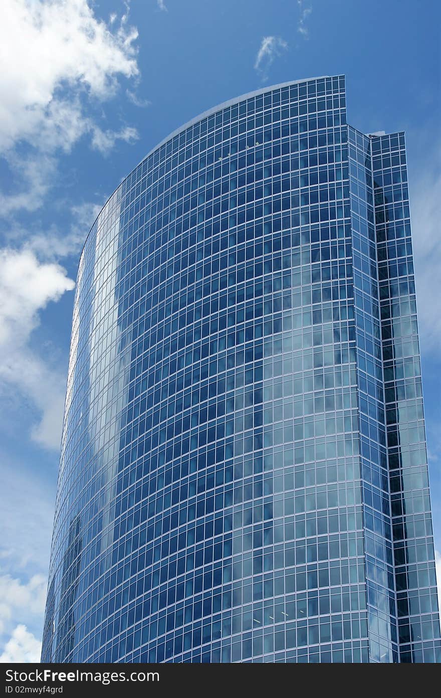 Reflection Of A Cloudy Sky In Glass Wall Of An Off