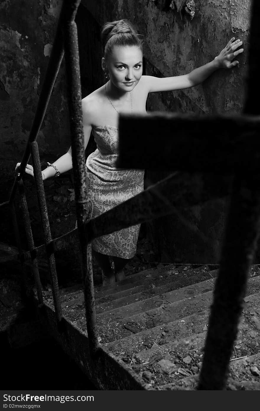 Beautiful Woman Standing On The Grungy Stairs