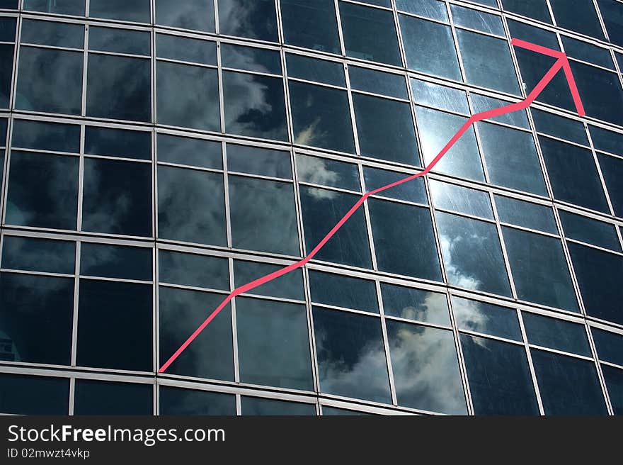 Reflection of a cloudy sky in glass wall of an office building