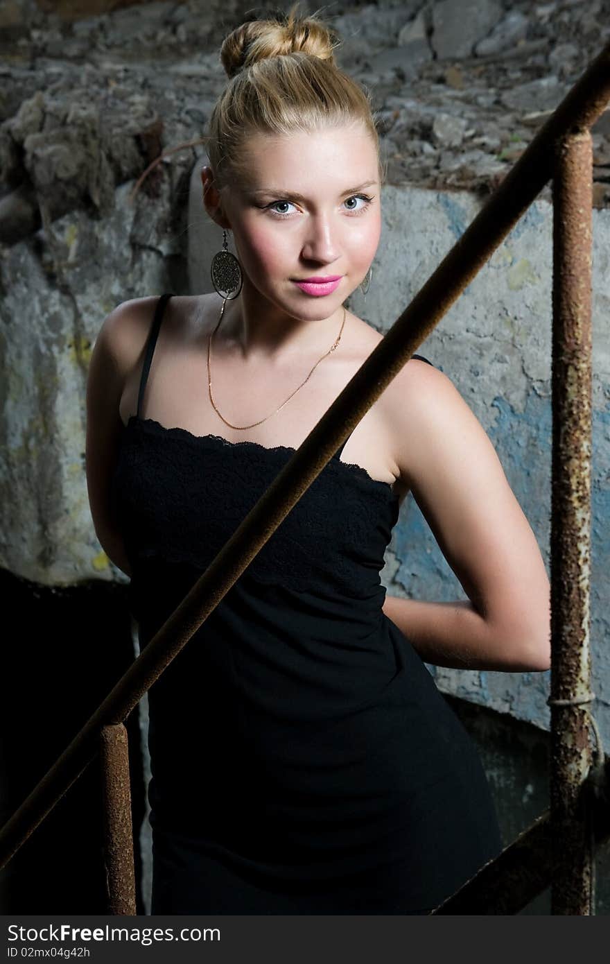 Beautiful chick standing on the grungy stairs. Beautiful chick standing on the grungy stairs