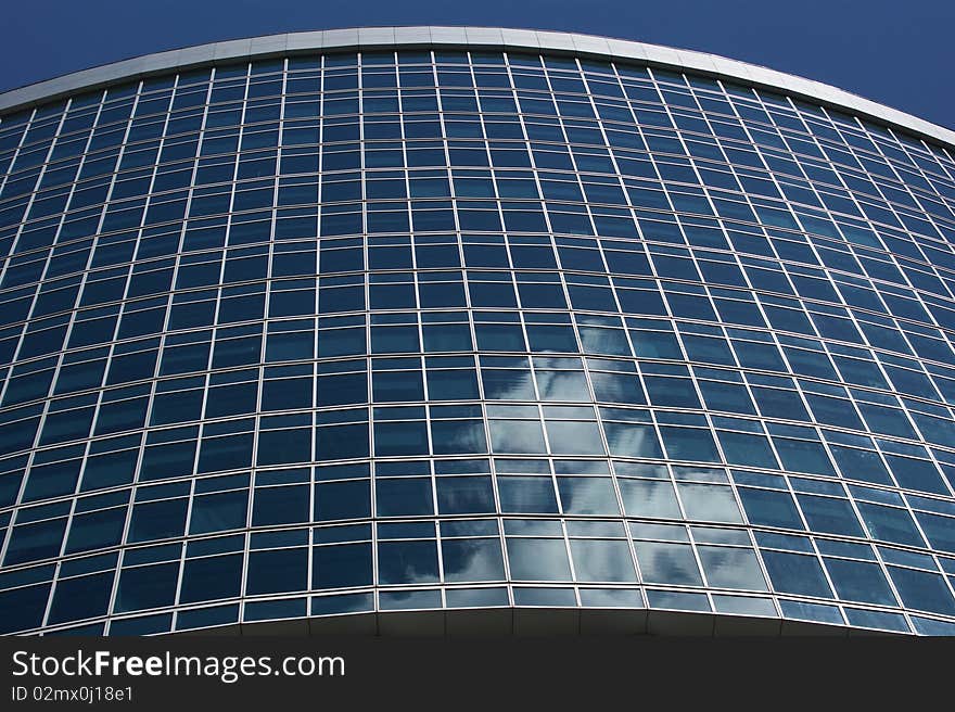 Reflection of a cloudy sky in glass wall