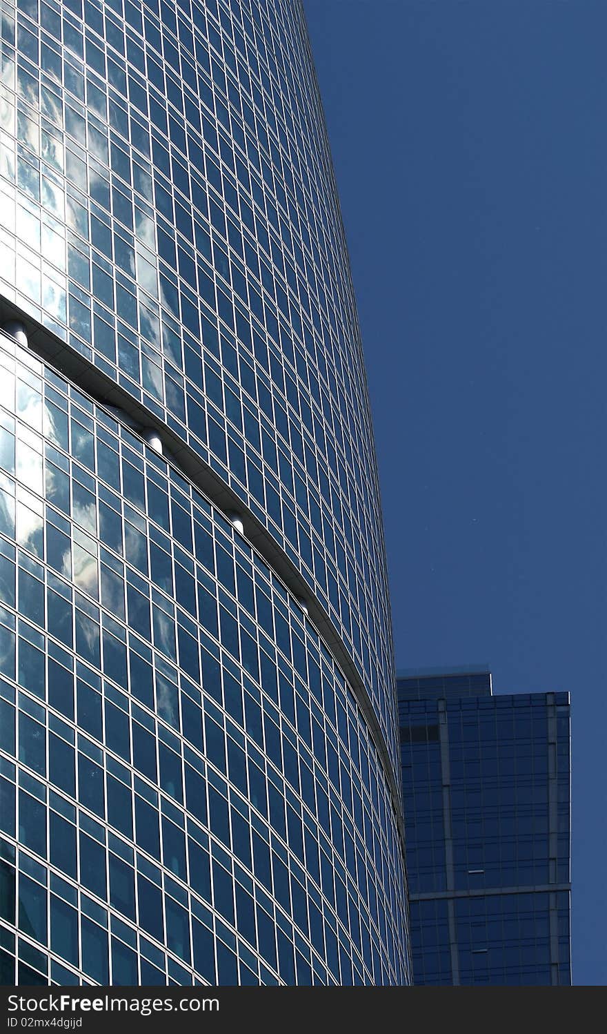 Reflection of a cloudy sky in glass wall