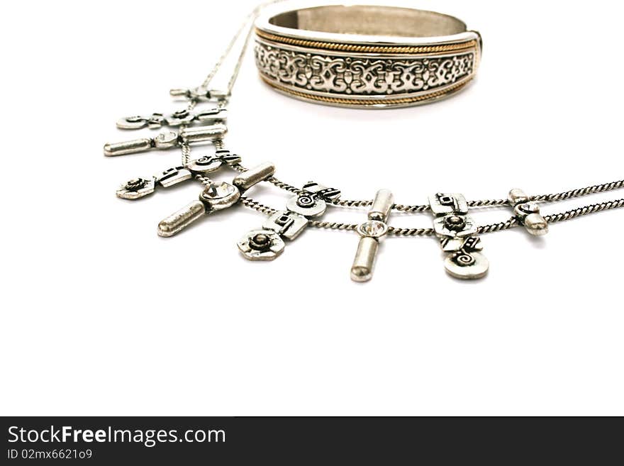 Silvery ancient style necklace and bracelet isolated on white background.