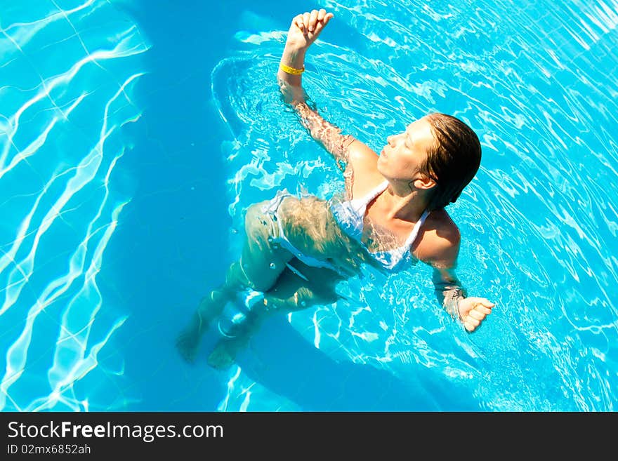 Woman in a pool hat relaxing