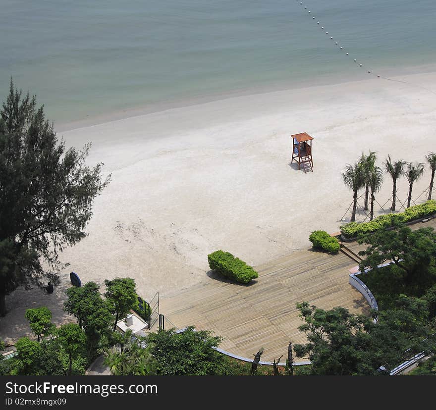 A quiet white beach in bright sunlight