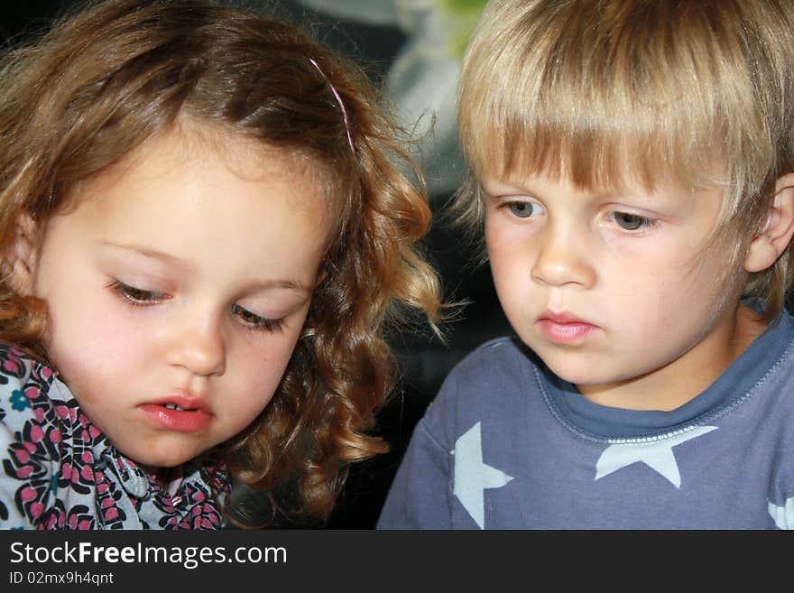 2 cute concentrated siblings playing