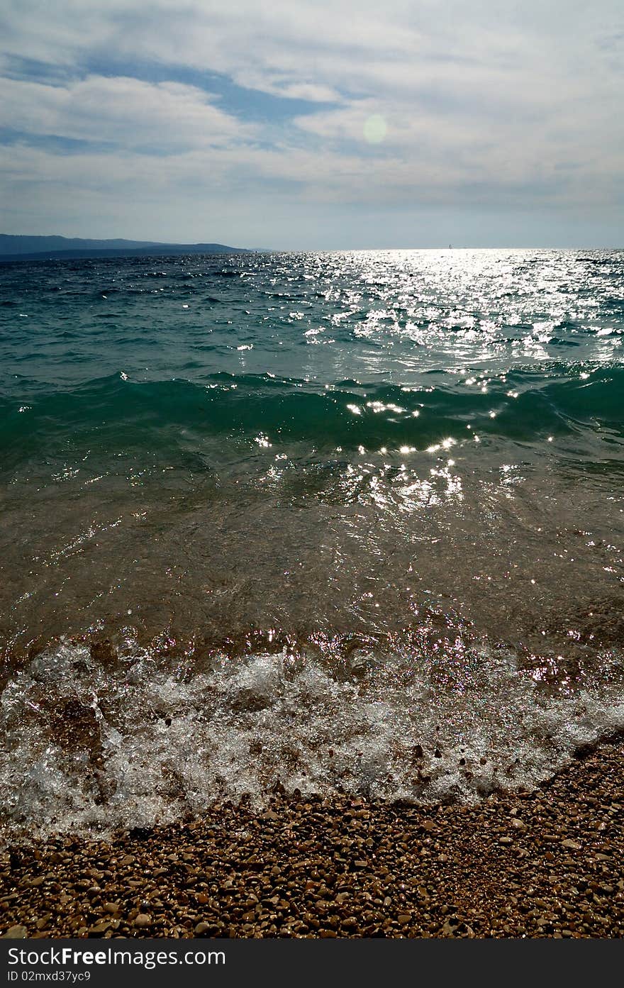 Glittering wavy beach