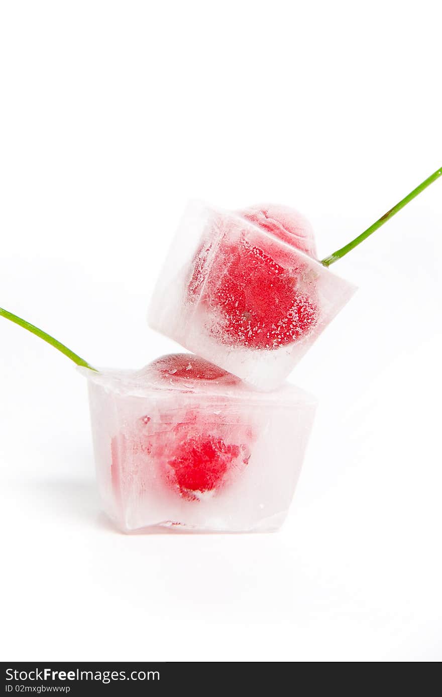 Two frozen cherries on white background.