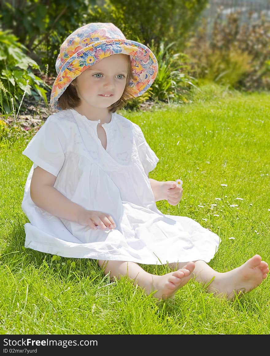 Tree years old girl in the garden