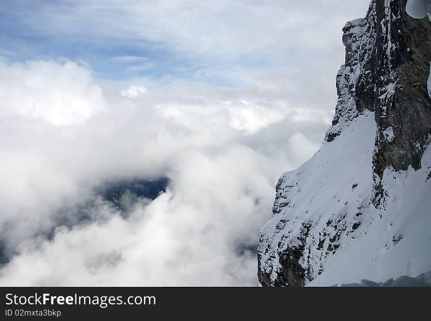 Snow mountains in cloudy weather