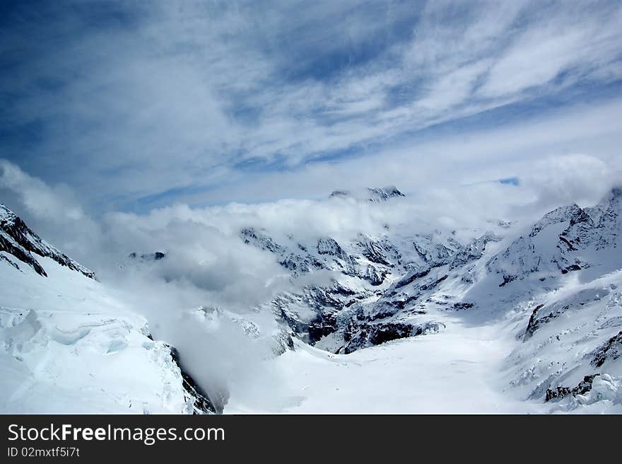 Snow mountains in cloudy weather