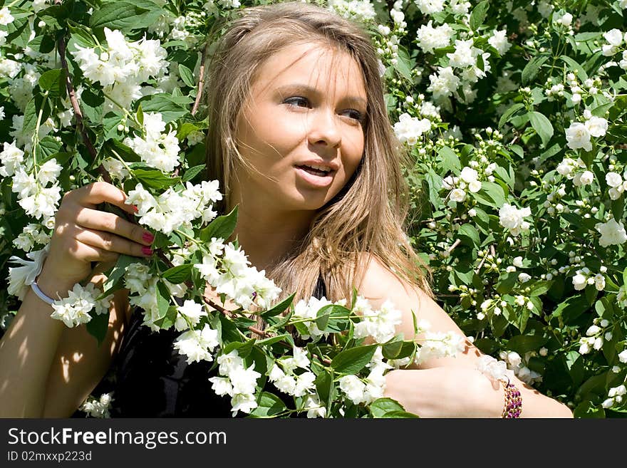 Girl standing near lilac