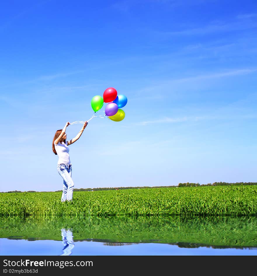 Girl with balloons on the field