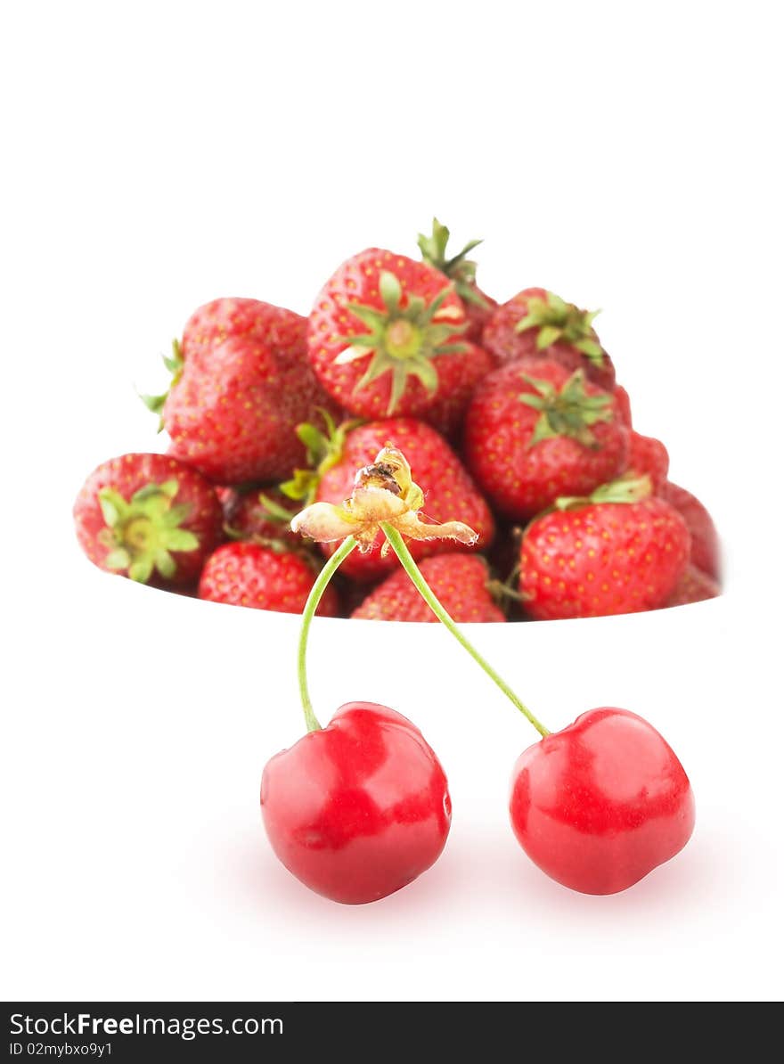 Ripe cherry on strawberry background over white