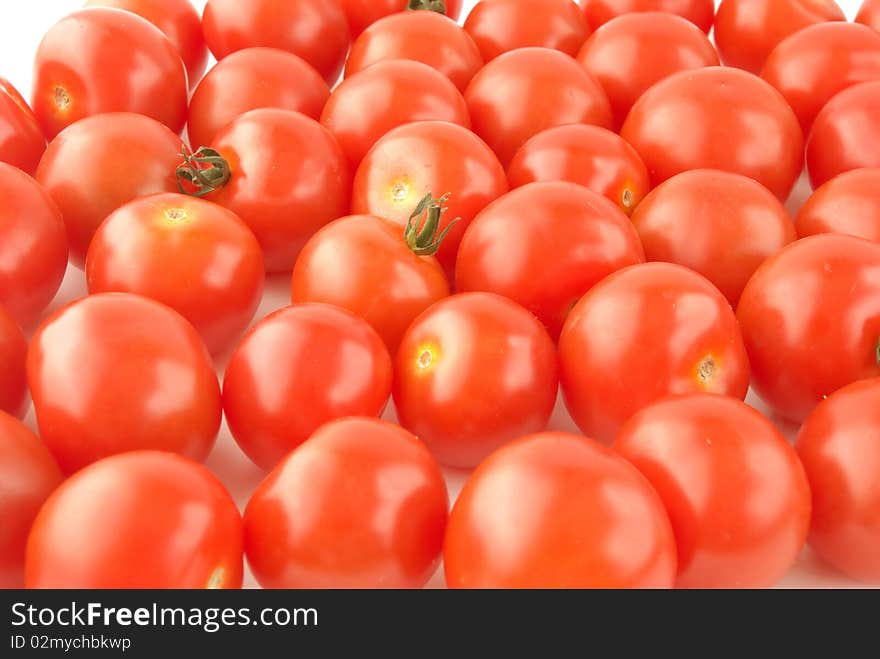 Shiny red cherry tomatoes background. Shiny red cherry tomatoes background