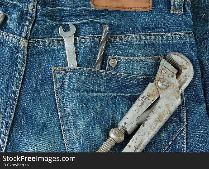 Work tools in jeans back pocket.