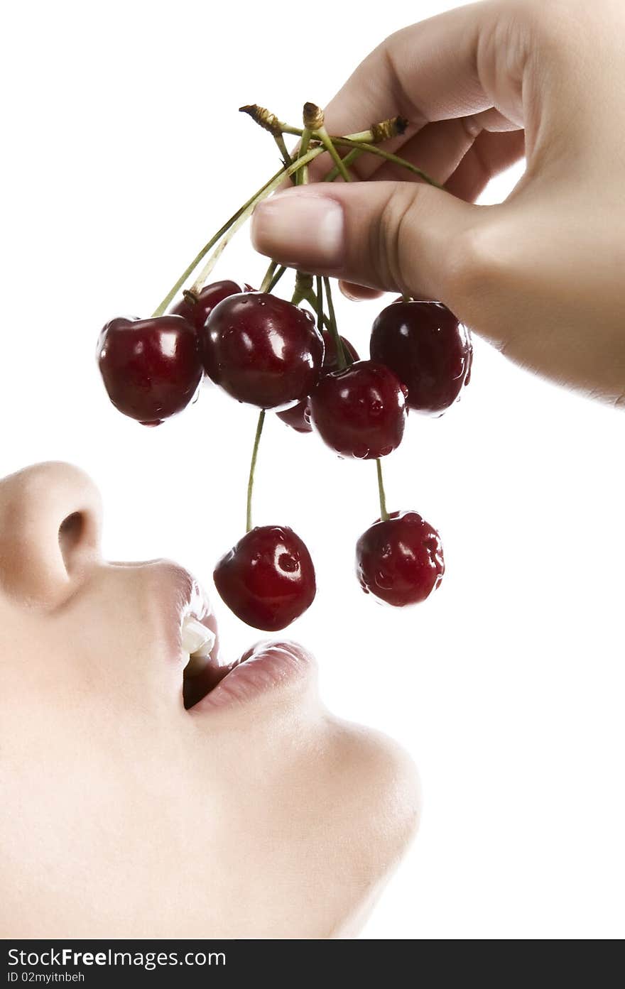 Sweet cherry in the girl's lips