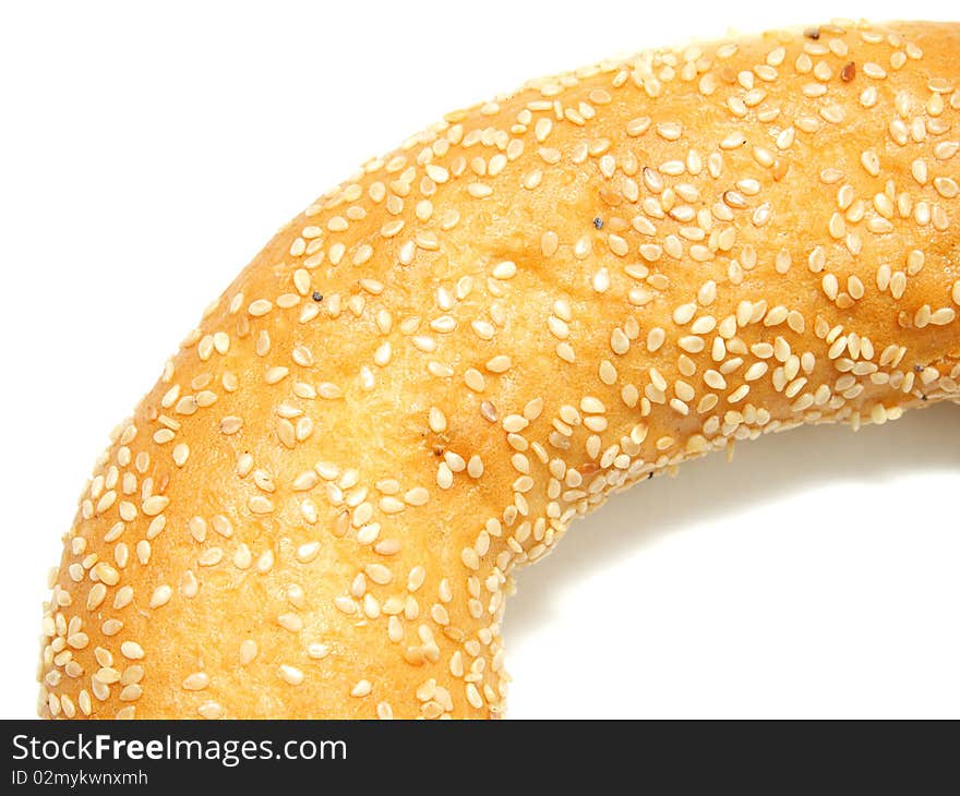 A part of bagel with sesame seeds