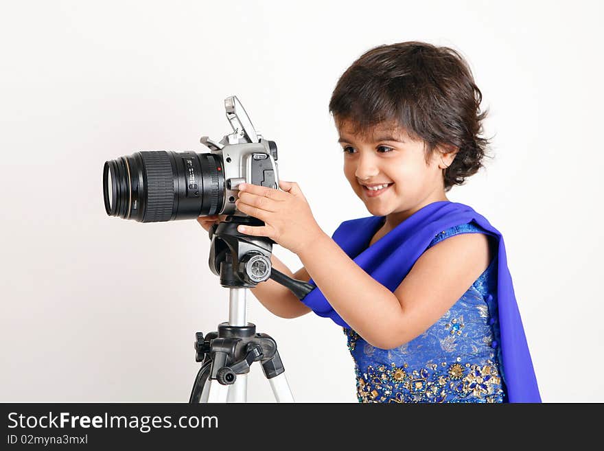 Sweet and pretty toddler playing with camera and taking picture.