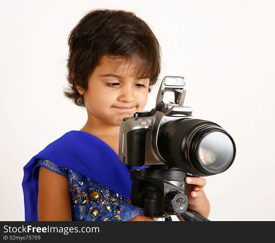 Sweet and pretty toddler playing with camera and taking picture.