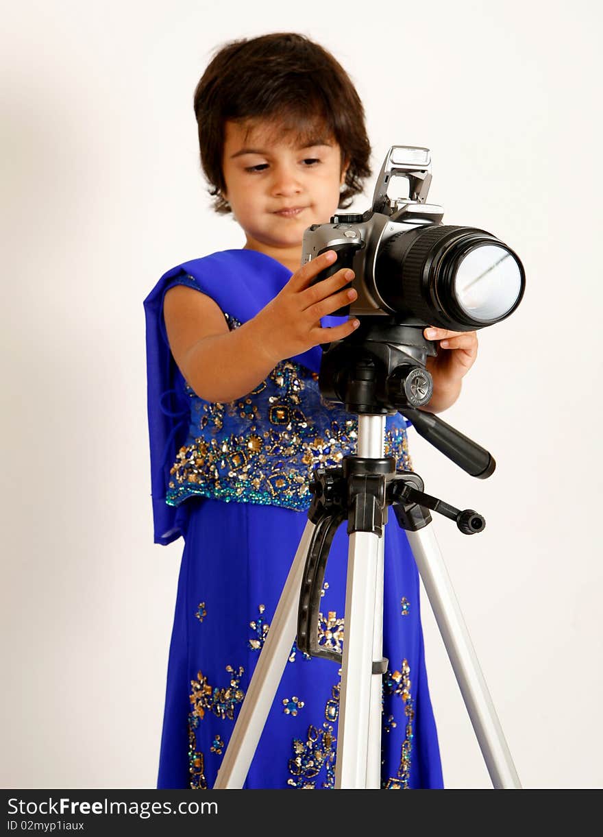 Sweet and pretty toddler playing with camera and taking picture.