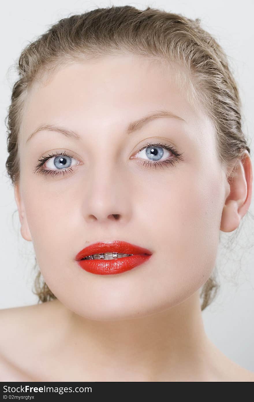 Close-up beautiful smile of atractive woman wearing dental braces.