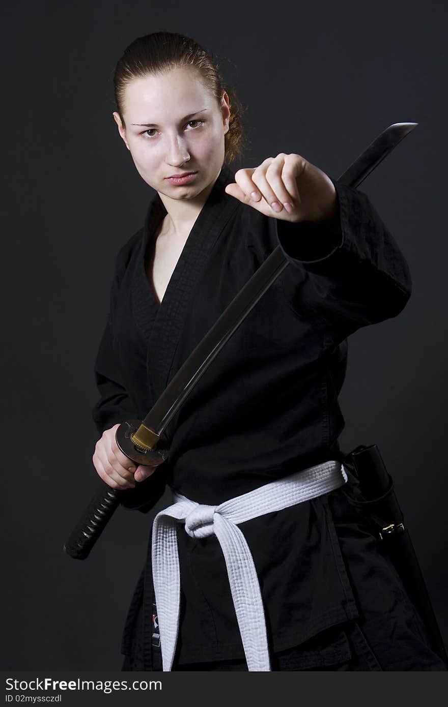 Female samurai holding katana, studio shot