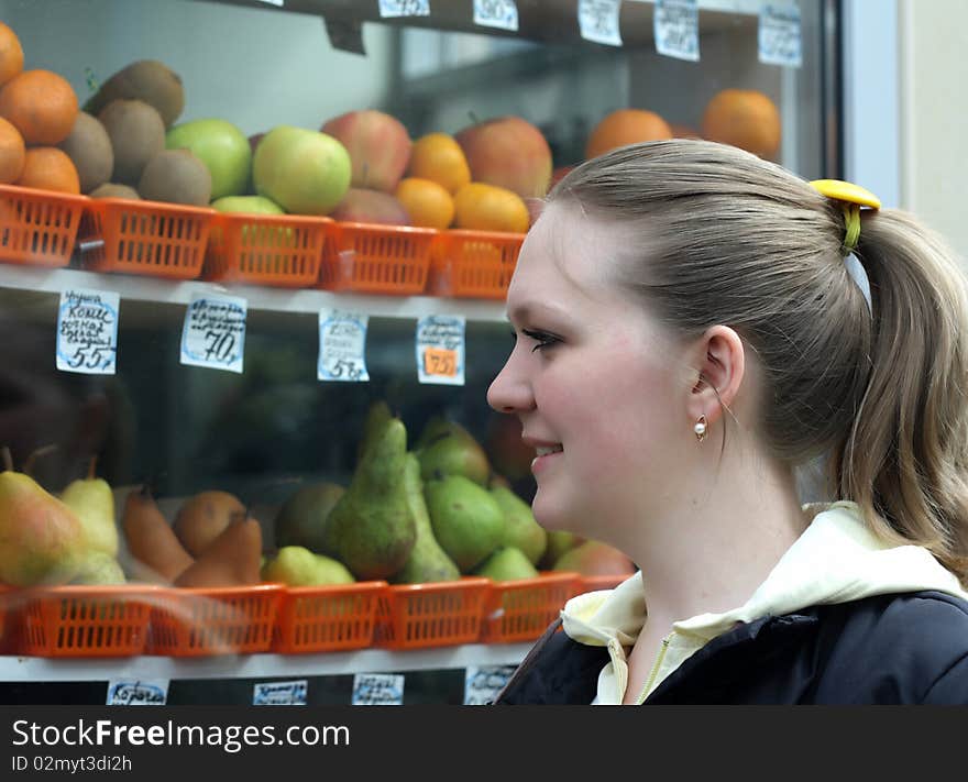 Young Woman Looking At Fruit