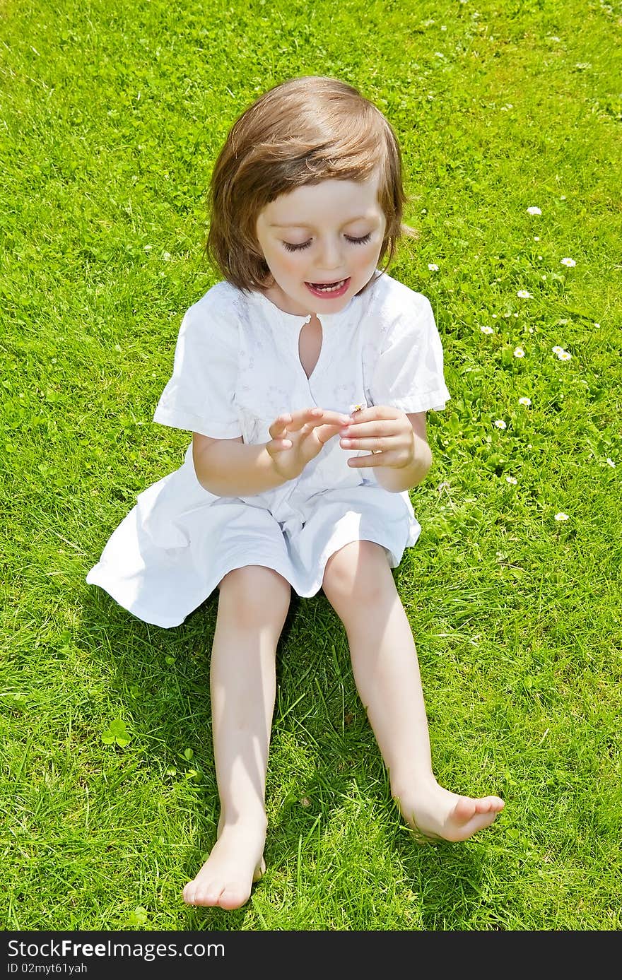 Three Years Old Girl With Daisy Flower