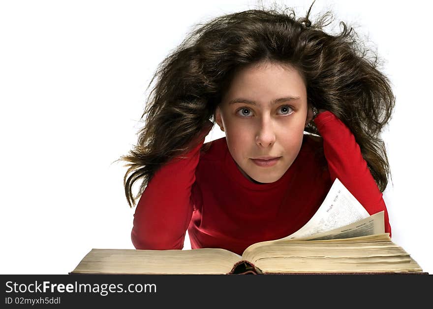 Girl in red cloth with big old book. Here hair is curl. Here hair is flying and shine. She rested his head with his hands. She look at the camera. Girl in red cloth with big old book. Here hair is curl. Here hair is flying and shine. She rested his head with his hands. She look at the camera.