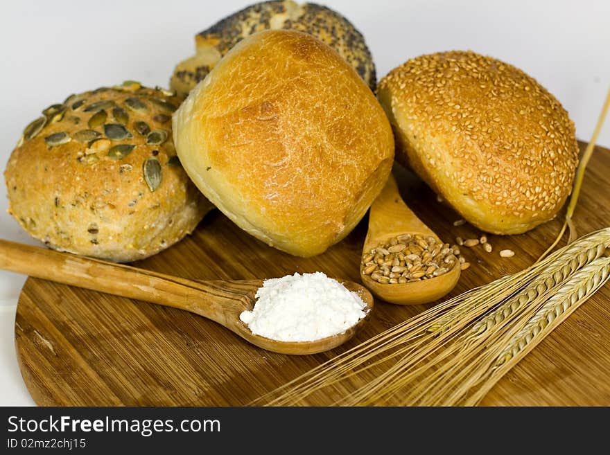 Roll bread with pumpkin and poppy seeds on the whi