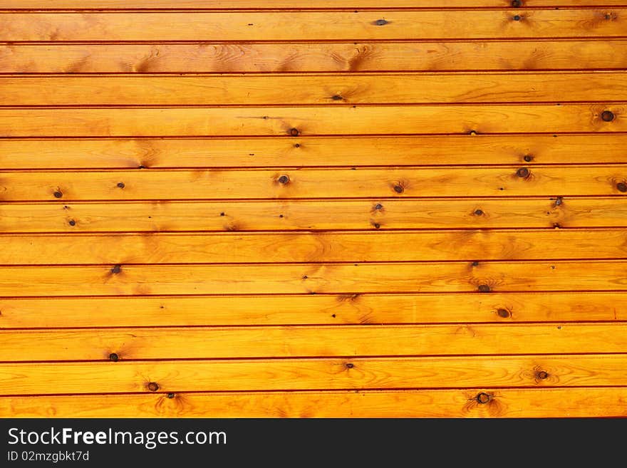 An outdoor wall made of wood planks painted in oil. An outdoor wall made of wood planks painted in oil.