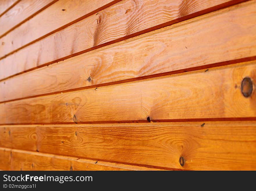 An outdoor wall made of wood planks painted in oil. An outdoor wall made of wood planks painted in oil.