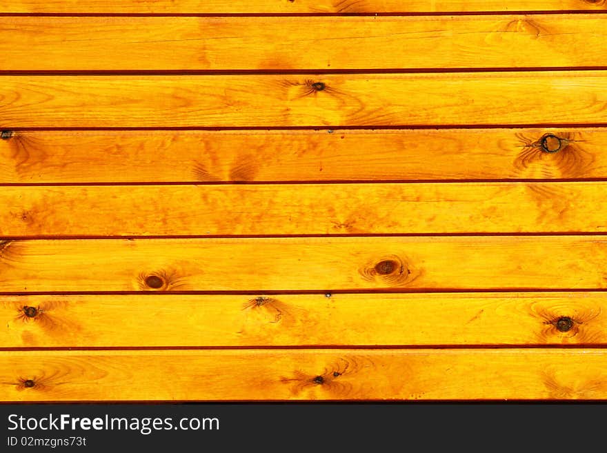 An outdoor wall made of wood planks painted in oil. An outdoor wall made of wood planks painted in oil.