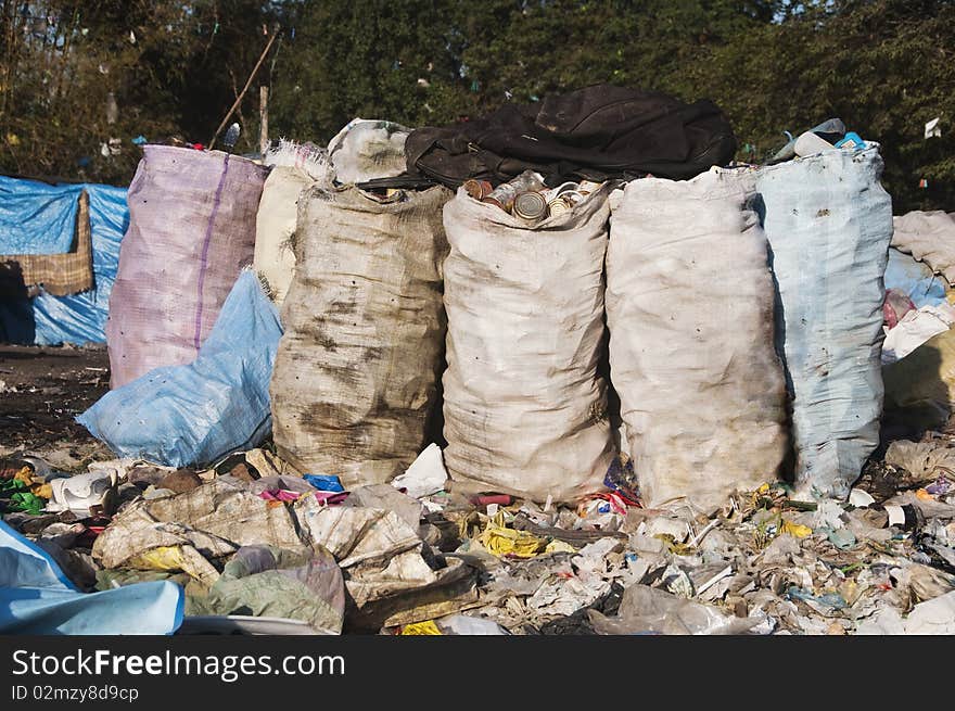 A sea of garbage starts to invade and destroy a beautiful countryside scenery. A sea of garbage starts to invade and destroy a beautiful countryside scenery