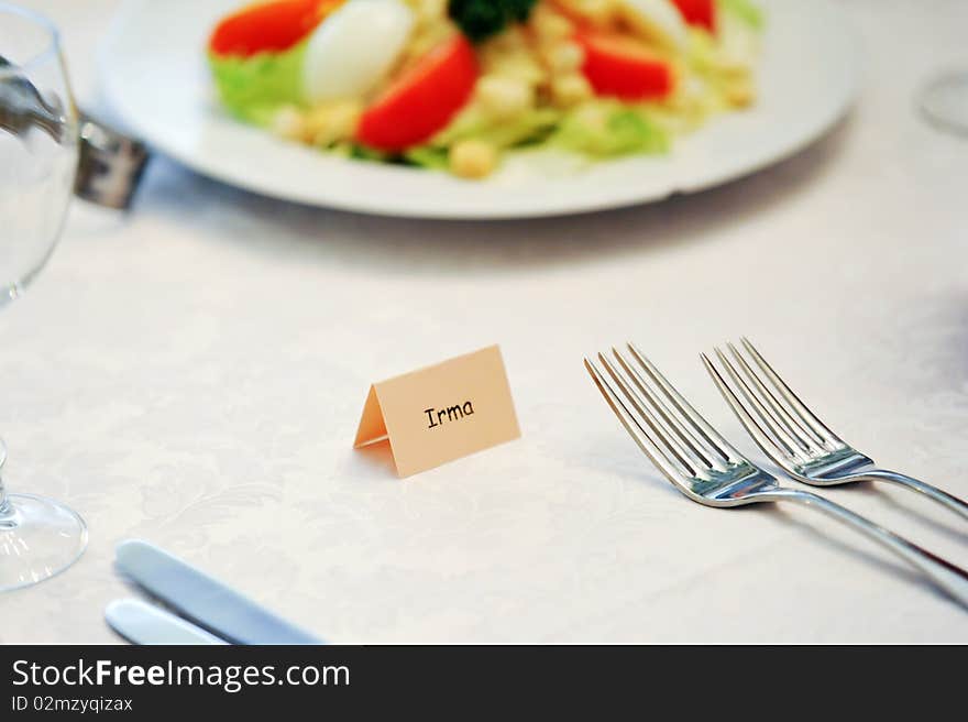 Table appointments for dinner in restaurant. Detail of table set for holiday dinner