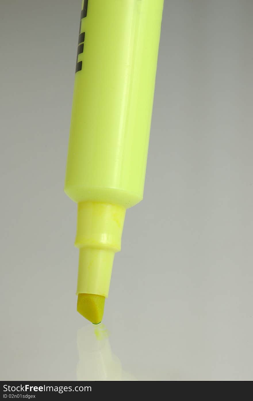 Yellow hi-liter marker on grey shiny surface
