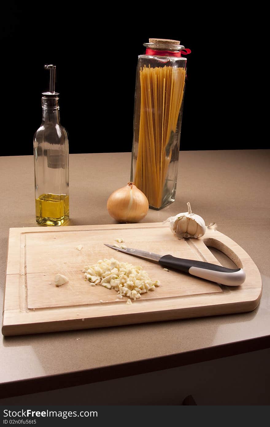 Wooden chopping board with chopped up garlic. Wooden chopping board with chopped up garlic