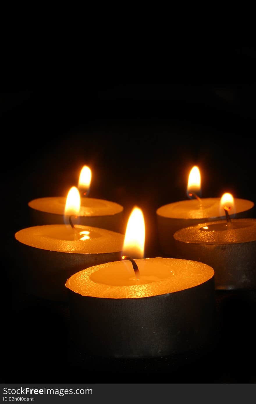 Burning candles on a dark background with warm light