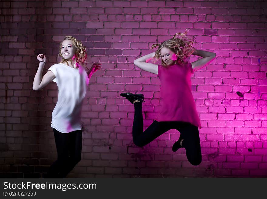 Teenage girl jump against purple background