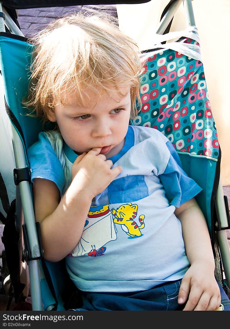 Portrait of thinking boy with a finger in his mouth. Portrait of thinking boy with a finger in his mouth